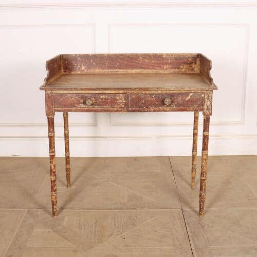 Pretty early 19th century English regency faux bamboo two drawer side table. 1820 30-inches to worktop. This piece is...