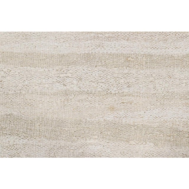 Handwoven in wool, circa 1950-1960, this 6x10 vintage kilim is among a special new curation of simple, near monochromatic...