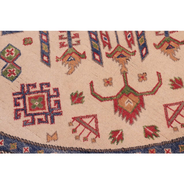 Enhance your home with this exquisite hand-knotted Kazak rug, crafted from fine hand-spun wool and dyed with all-natural...