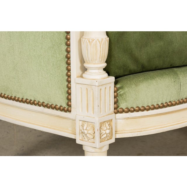 A refined French Louis XVI style canapé sourced in Provence, dating to the early 20th century featuring a gently curved...