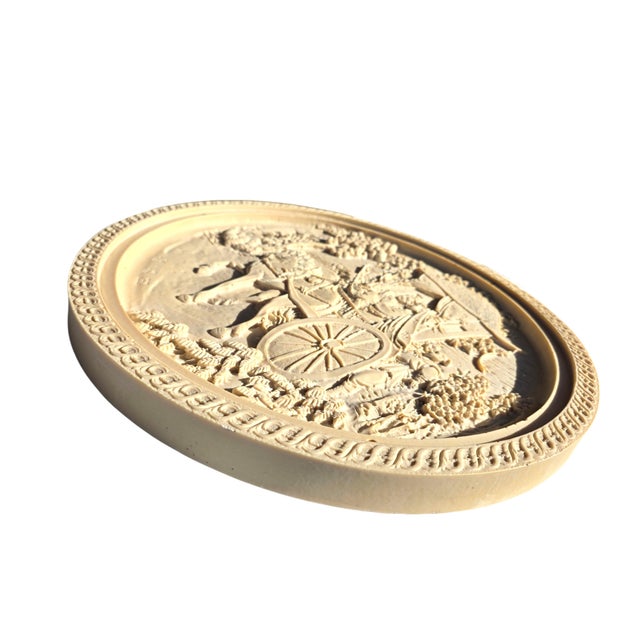 This substantial 18-inch carved alabaster wall medallion brings classical elegance and sculptural texture to any interior....