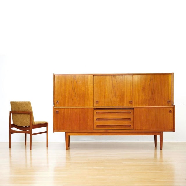 A striking Danish modern teak highboard credenza attributed to Johannes Andersen. (Denmark). Featuring an exceptionally...