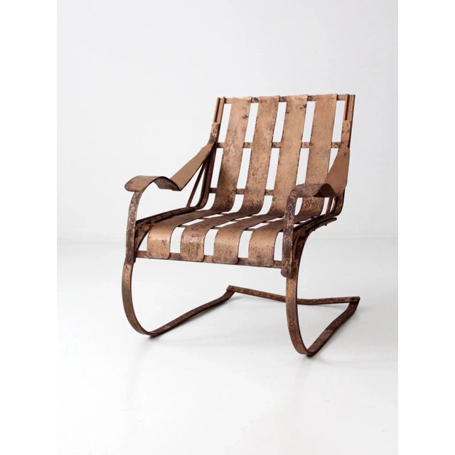 This is a 1950s vintage patio bouncer chair featuring a classic metal lawn chair design with a traditional bouncer frame...