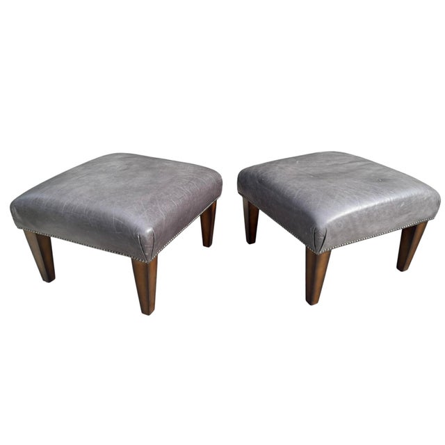 A handsome pair of King Hickory leather ottomans upholstered in supple gray leather with decorative nailhead trim and...