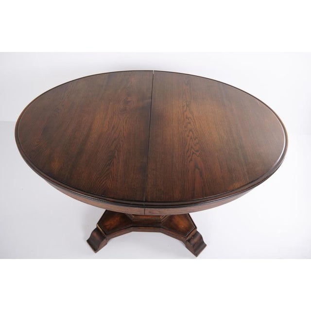 Dining table in Empire style from the 1820s, crafted in mahogany as a classic pedestal table with a rectangular top. A...