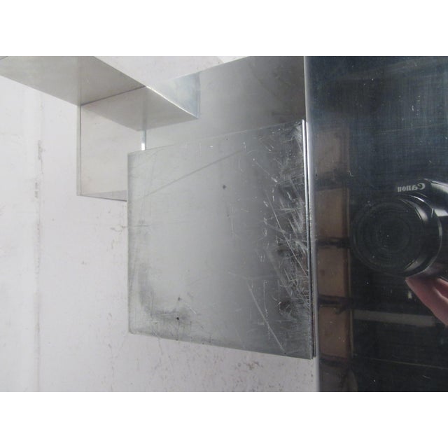 This beautiful vintage modern coffee table features a metal cityscape style base and an extremely thick glass top with a...