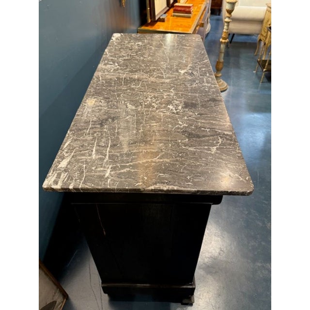 The 19th Century French Ebonized Louis Philippe Commode is a luxurious and elegant piece of furniture that adds a touch of...