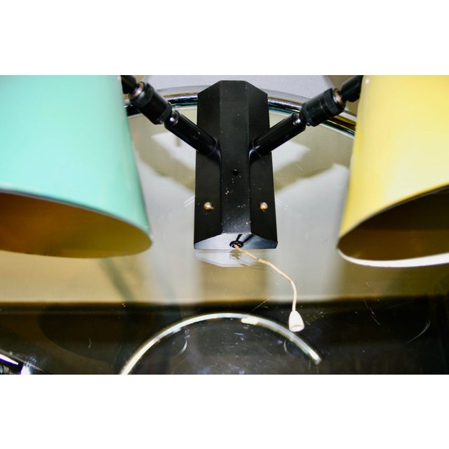 It features a double cone design in lacquered sheet metal and a black lacquered brass frame. They have double joints...