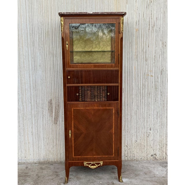 About An extremely high quality and elegant French late 19th century Louis XVI period mahogany and ormolu-mounted cabinet...