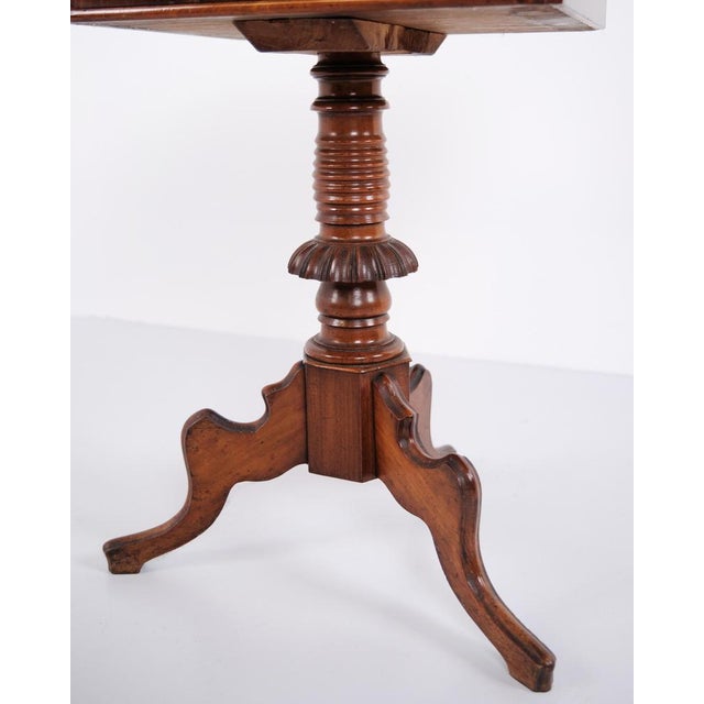 Pedestal table crafted in hand-polished mahogany dating from around 1860. The table features a classic pedestal base and...