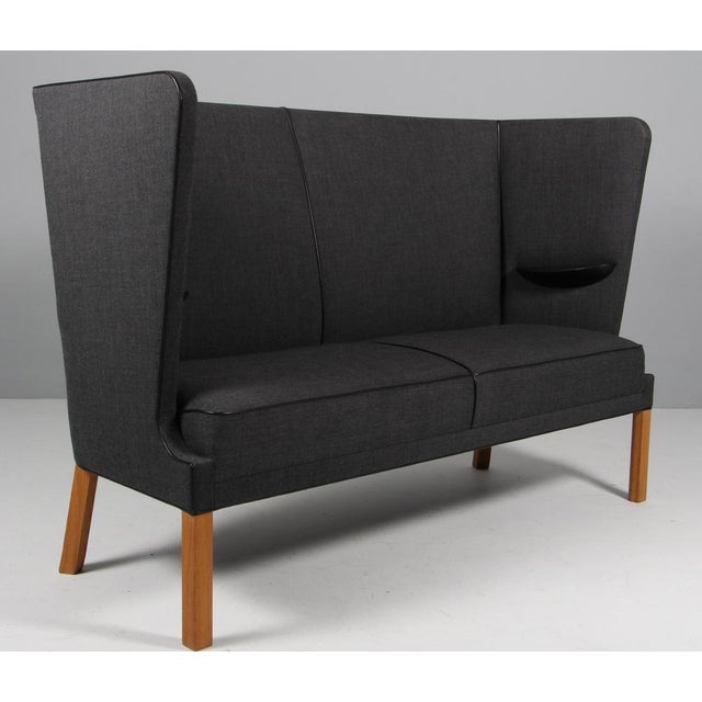Frits Hennignsen two seater Coupe sofa with fabric and leather tubings. Frame of oak. Model FH436, made by Carl hansen....