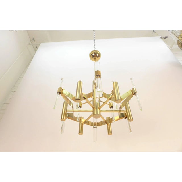 Gold-plated metal and faceted crystal chandelier by Gaetano Sciolari. Rewired for US. Nine candelabra sockets. Max 60 watt...