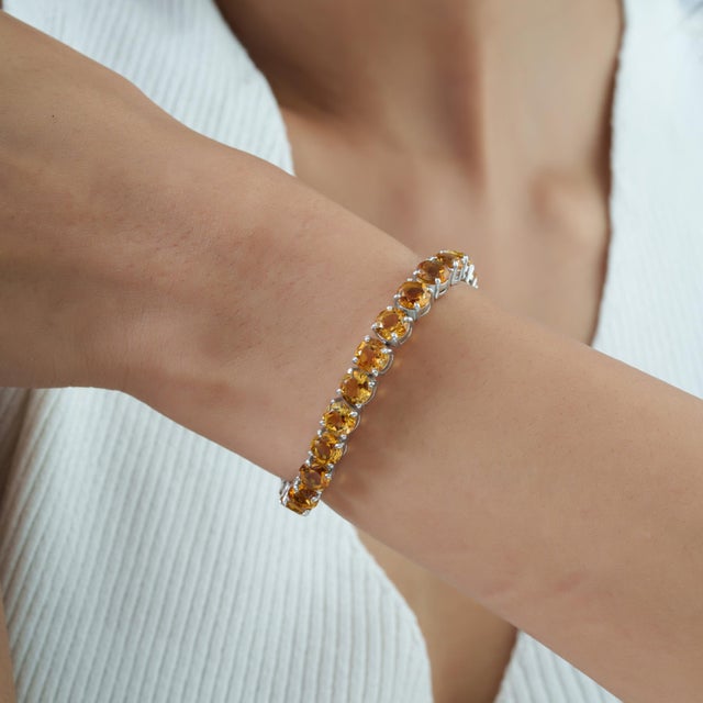 This Retro tennis bracelet features 26.4 carats of natural round-cut citrine, with each gemstone measuring approximately 6...