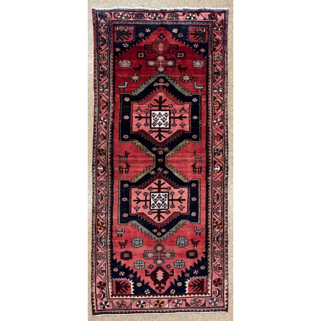Antique Hand-knotted runner from the Hamadan region of western Iran, featuring three large stepped geometric medallions...