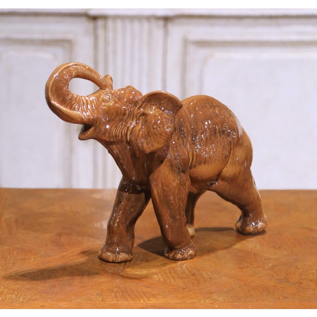 This charming mid-century Italian ceramic elephant sculpture, crafted circa 1950–1960, features a lively depiction of the...
