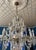 A dramatic and elegant antique French-style crystal chandelier featuring hand-blown glass arms, cascading cut crystal...