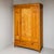 Single-door softwood wardrobe with two drawers and a clean, linear body. The diamond-shaped brass escutcheons add a...