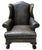 A handsome English Georgian-style wingback library armchair, upholstered in richly patinated distressed olive green...