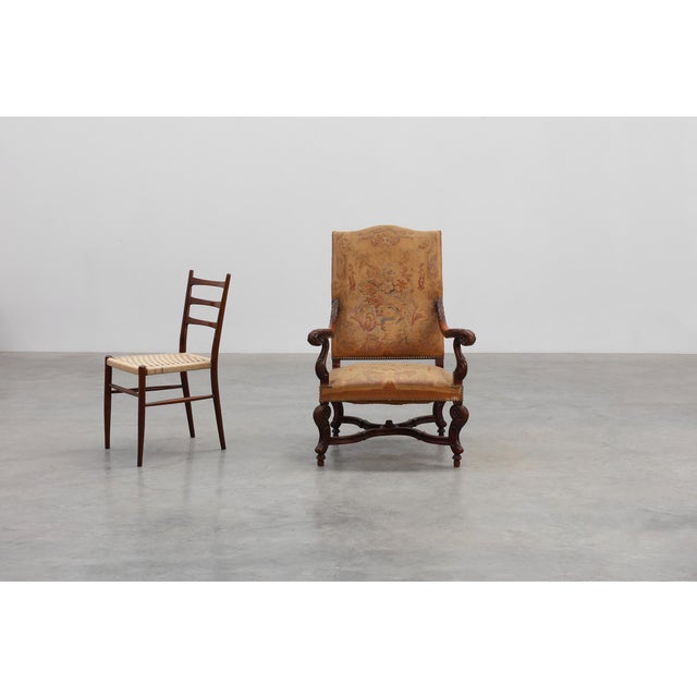 A beautifully expressive French walnut armchair dating to around 1800, offering decorators a richly textured blend of...