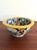 Colorful hand painted Mexican pottery bowl in the traditional Talavera style, characterized by intricate geometric,...