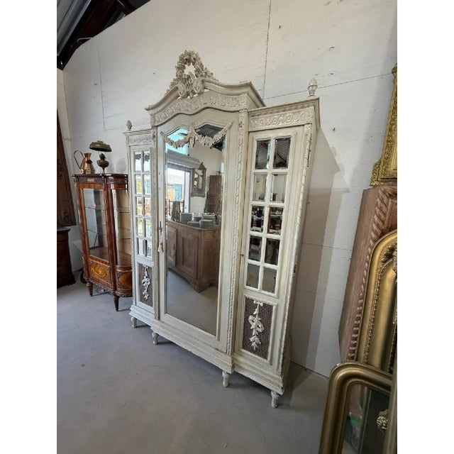 large French louis XVI 3 door bookcase or Armoire made of solid walnut. The wood has the original French paint from the...