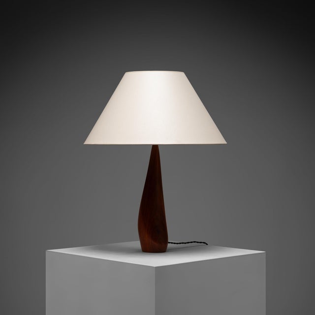 The lamp, designed by ernst henriksen, is defined by its beautifully sculpted teak-wood stand, which tapers elegantly from...
