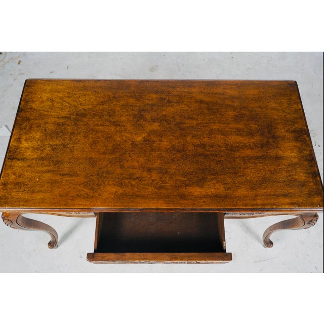 An elegant vintage writing desk or console table in the French Louis XV tradition. Its generously proportioned rectangular...
