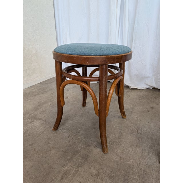 This pair of vintage bentwood stools features classic curved wooden legs bentwood design. The stools have round...