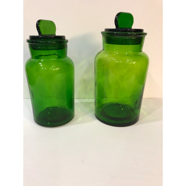 These are a beautiful set of all glass apothecary jars in bright green. Measurements: Width 4.5”; Depth 4.5”; Height 9”...