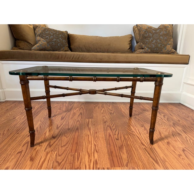 Classic in design and eluding to Hollywood Regency style this faux bamboo metal and glass top coffee table might be the...