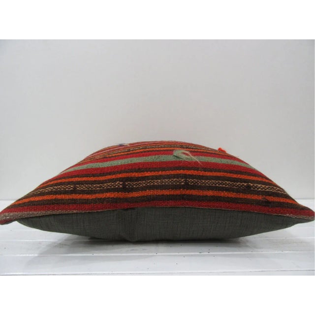 This is a pillow cover made from a vintage kilim rug. The piece was properly washed and ready to use. Pillow inserts not...