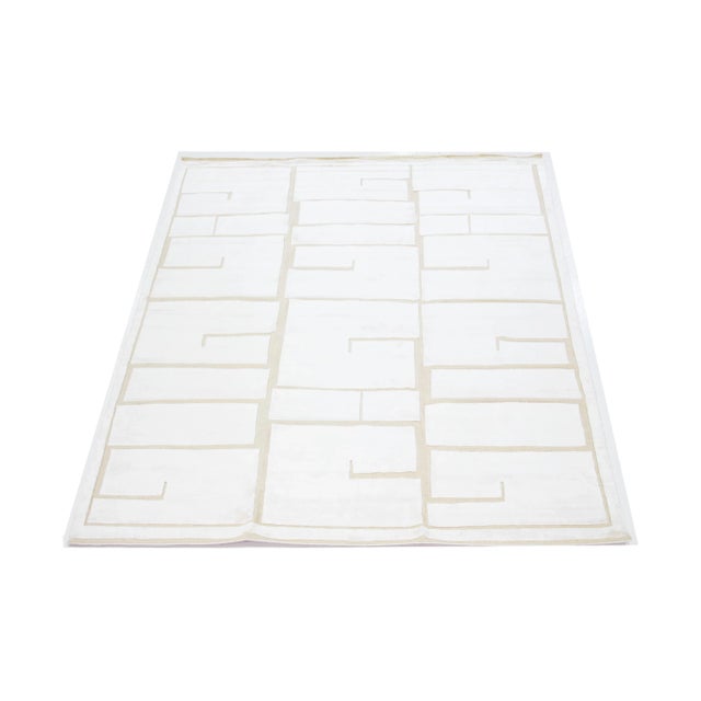 This hand-knotted wool rug showcases a modern Moroccan-inspired motif highlighting understated ivory hues against a bold...