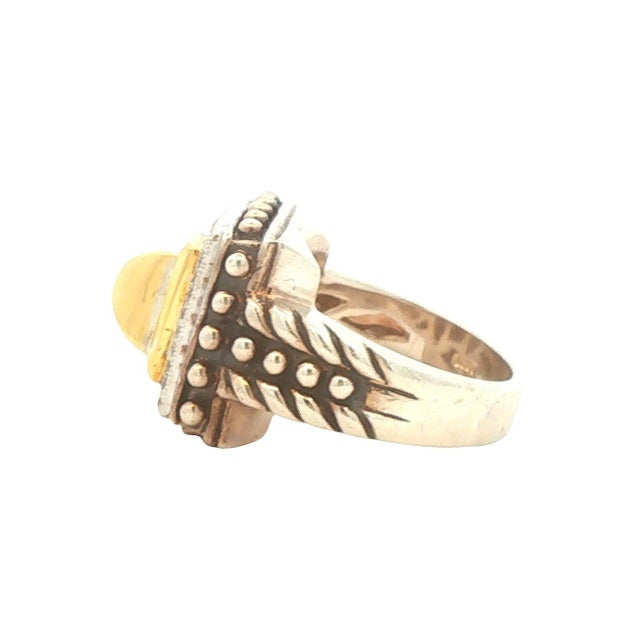 A fashion ring crafted by BJC in the United States. The design features a central square motif in 18k gold, surrounded by...