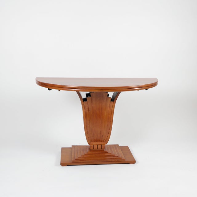The piece was traditionally restored and crafted from lemon mahogany. The tabletop is covered in leather and decorated...