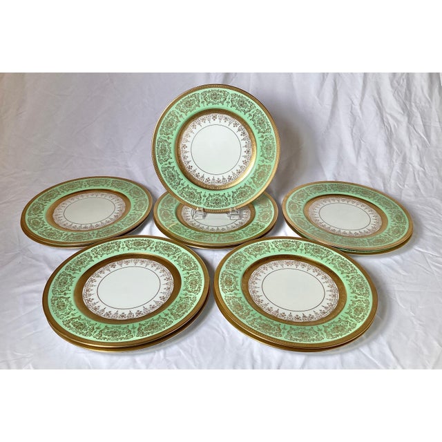 An elegant set of 11 Edgerton lacy gilt service plates with an apple green border. A thick gold band border with an inner...