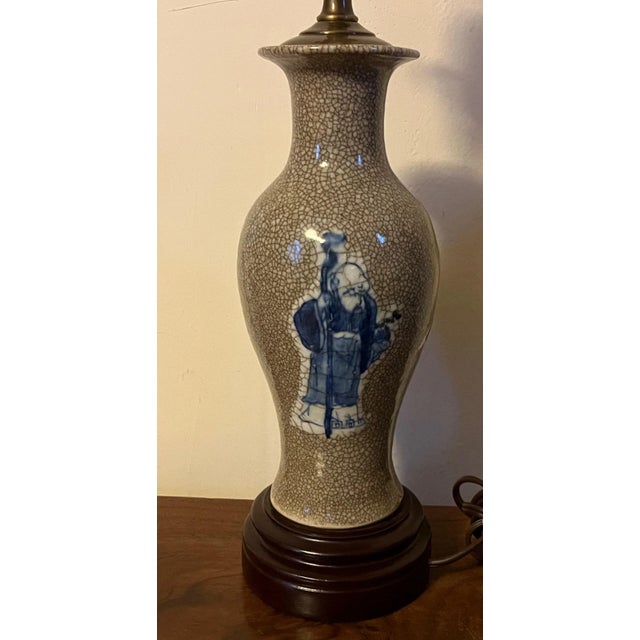 Antique 19th century Chinese export blue & white porcelain crackle glaze vase mounted as a lamp. Decorated with figures in...