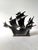 Heavy cast iron with original or vintage cold-painted polychrome finish. Modeled as an antique caravel/galleon riding...