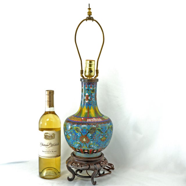An antique Chinese cloisonné enamel vase converted into a table lamp. The central base is crafted using a traditional...