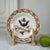 A wonderfully expressive antique French tin-glazed faience plate, hand painted with a stylized exotic bird perched on a...
