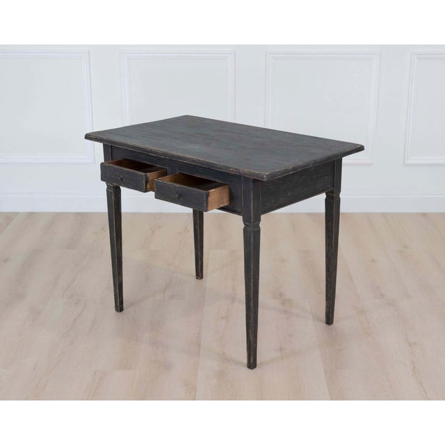 A charming early 19th century Gustavian writing desk featuring elegant provincial craftsmanship and beautifully aged...
