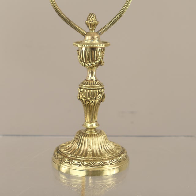 Solid brass base with a polished surface, featuring its original acid-etched frosted glass shade with floral details...