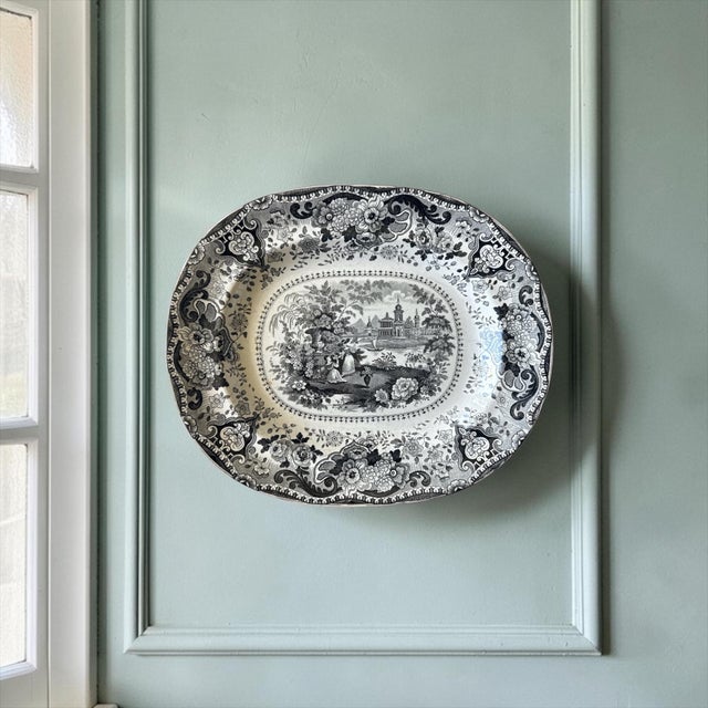 A beautifully detailed early 19th-century English transferware platter in the sought-after “Italian Buildings” pattern by...