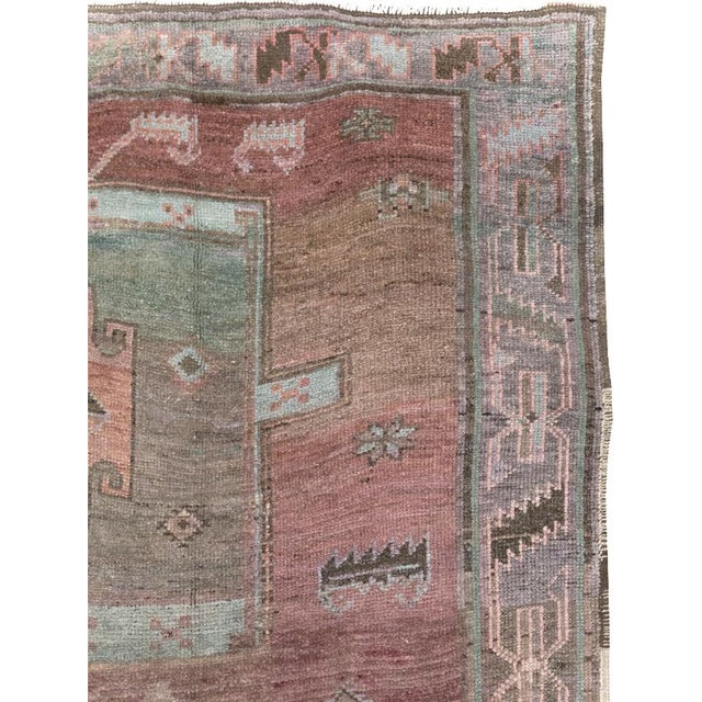 A wool pile of symmetric knots on a mostly cotton, some wool foundation. This softly toned room size piece shows its...