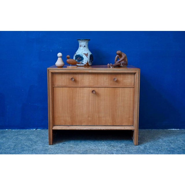 Compact yet with ample storage, this vintage bedside table dates back to the 1950s. The top drawer and the drop-down door...