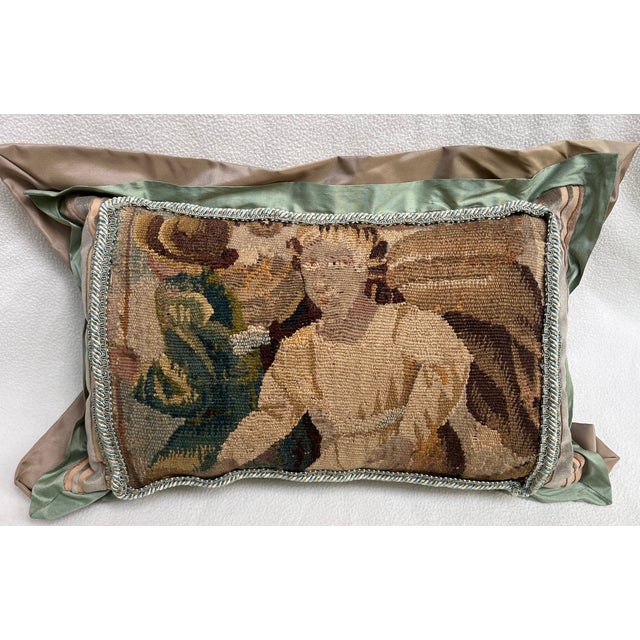 Decorative pillow made from an 18th-century tapestry fragment depicting a male figure, woven in wool and silk and...