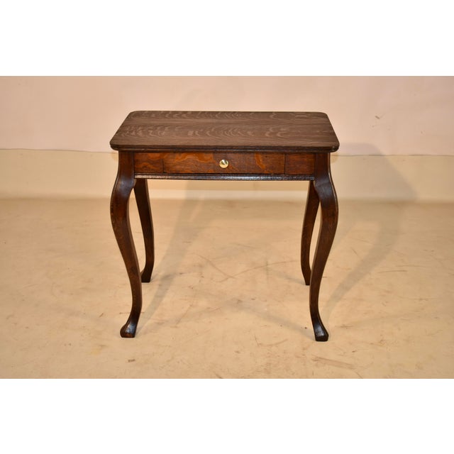 Circa 1900 French oak side table with a beautifully grained top with so much motion it is stunning! The top follows down...