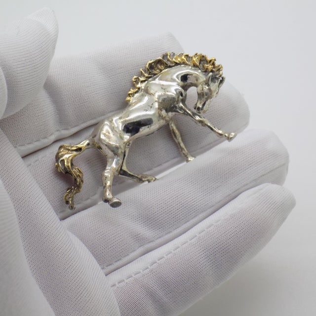 A decorative vintage miniature depicting a horse with gilded accents, handmade in Arezzo, Tuscany, Italy between the 1980s...