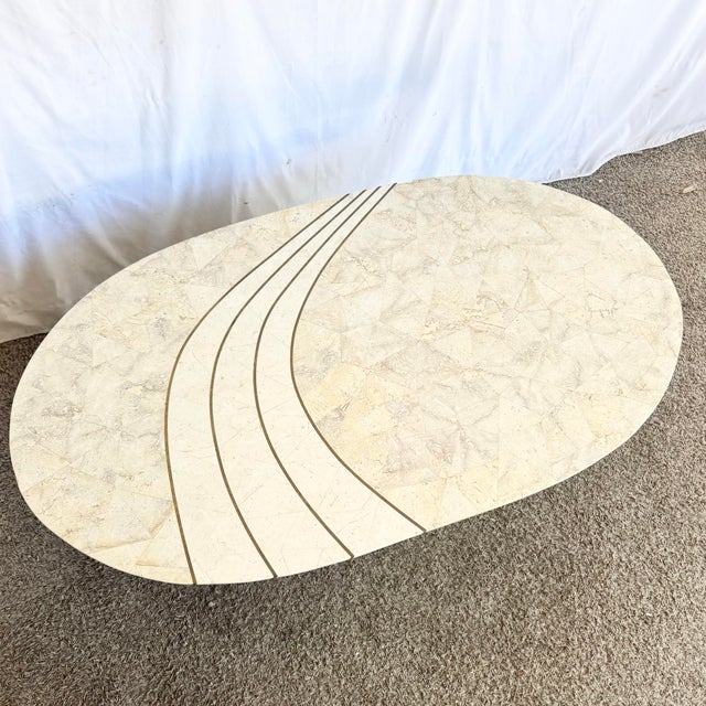 A distinctive vintage postmodern coffee table crafted from tessellated stone, showcasing the sculptural geometry and bold...