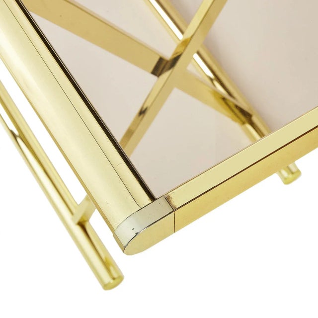 Beautiful vintage modern brass and smoked glass console table with a brass X frame and sled base.