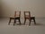 Pair of handcrafted solid oak chairs with a distinctive sculptural character. Each features four splayed, shaped legs...